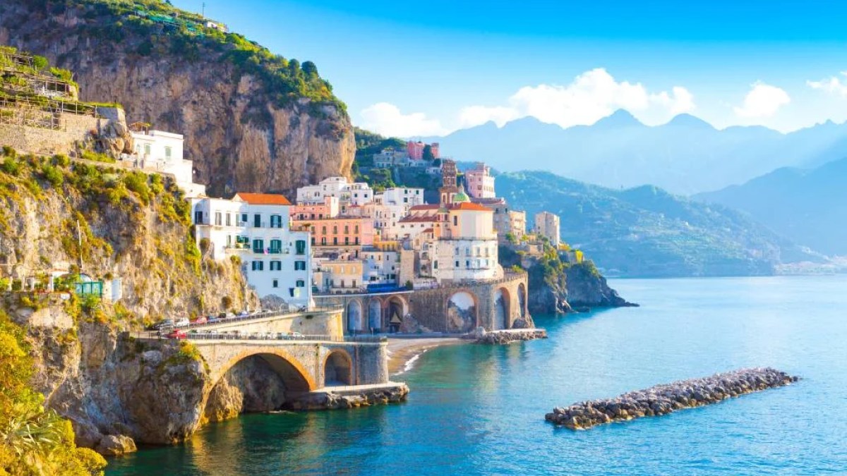 a body of water with a mountain in the background