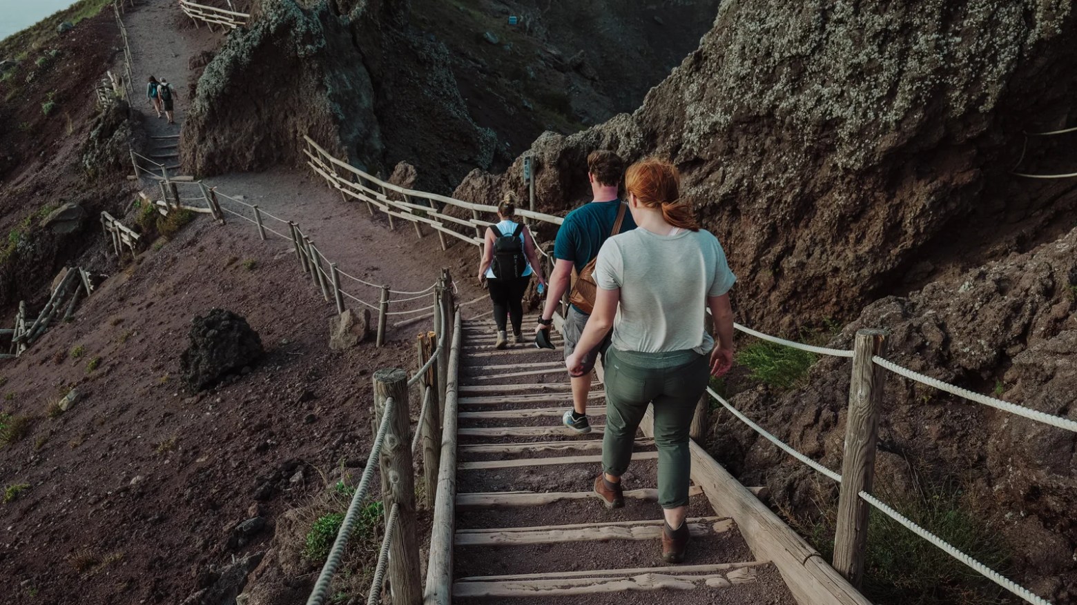 a group of people walking on a bridge
