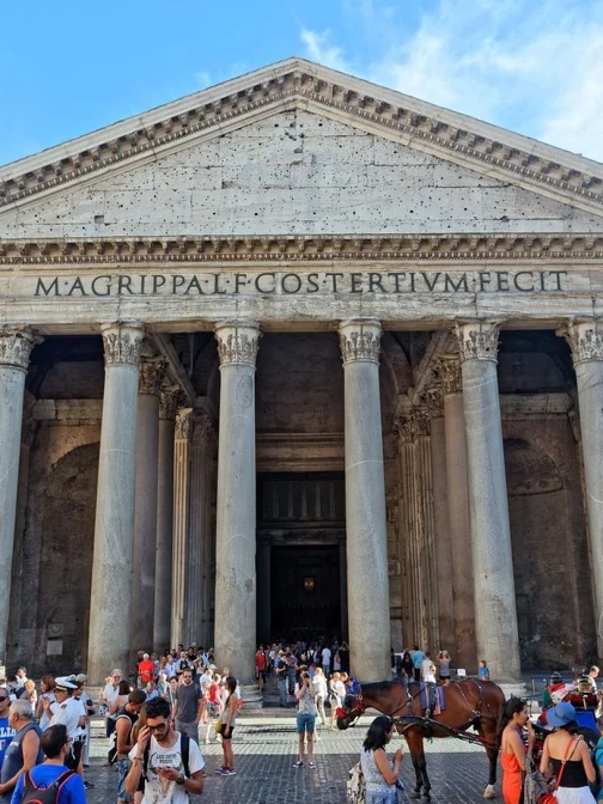 a group of people walking in front of Pantheon, Rome