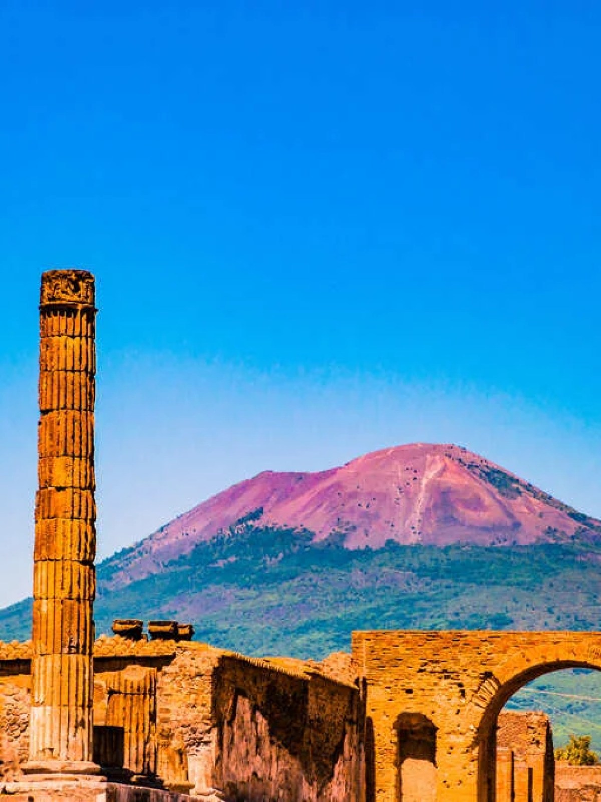 a large building with a mountain in the background