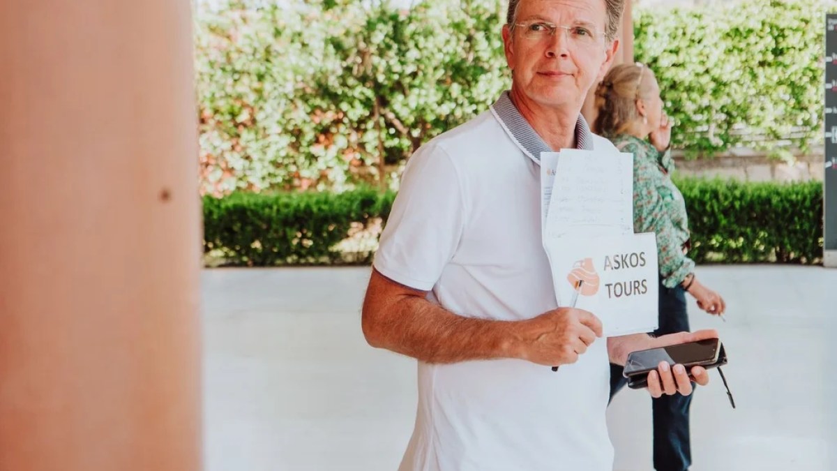a man holding a sign posing for the camera