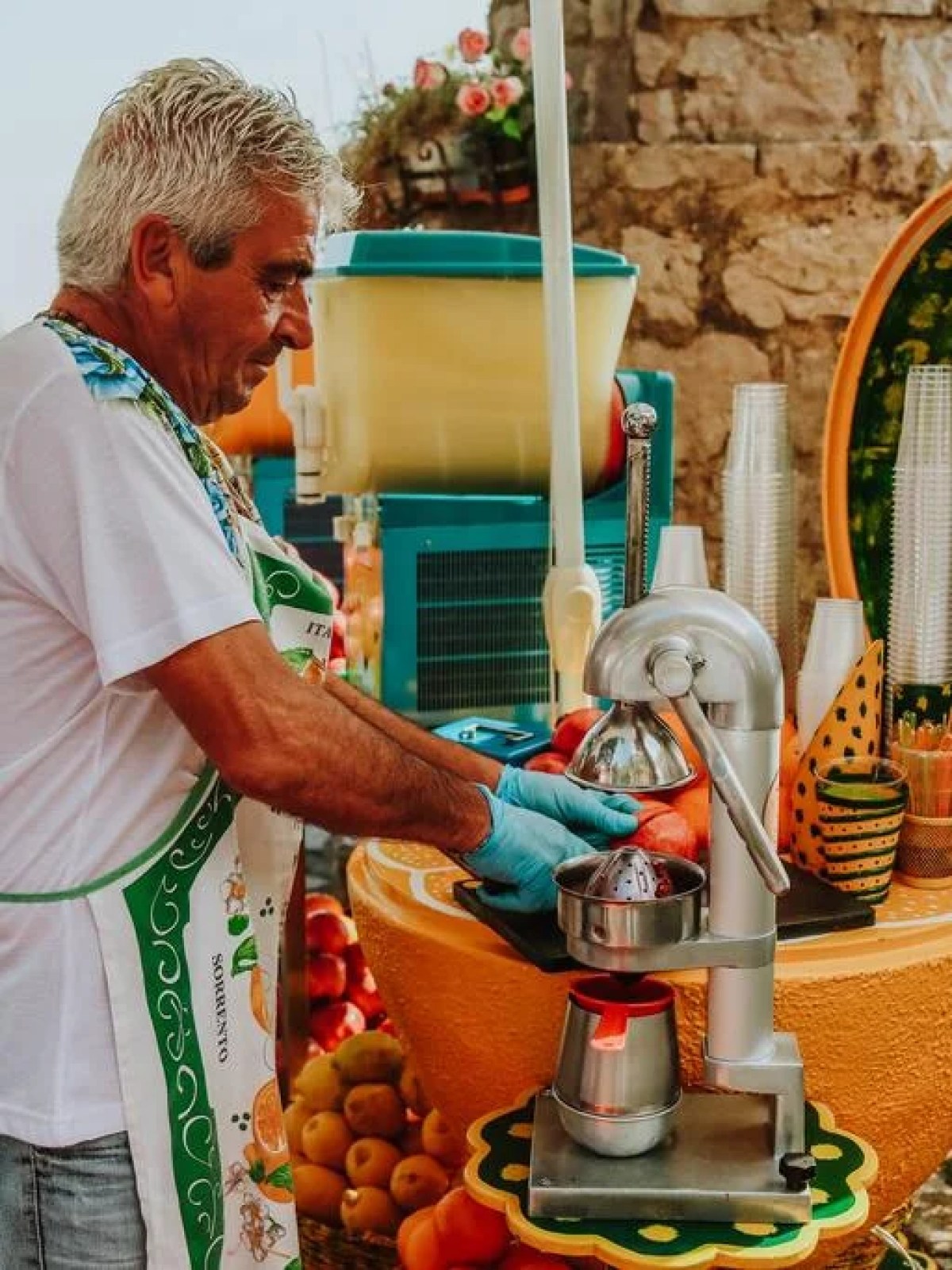 a man and a woman standing in front of a fruit stand