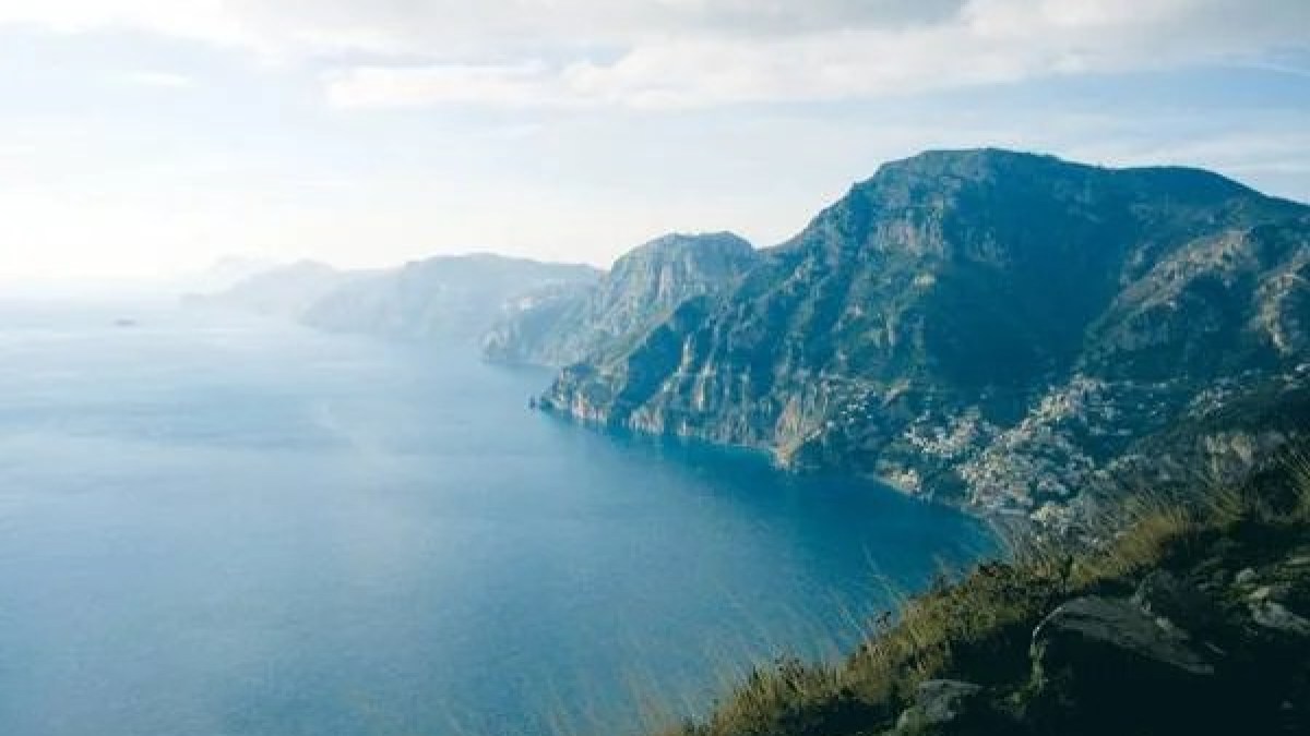 a view of a body of water with a mountain in the background