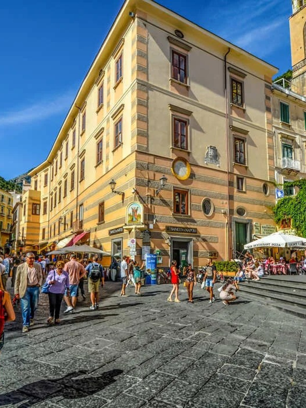 a group of people walking in front of a building