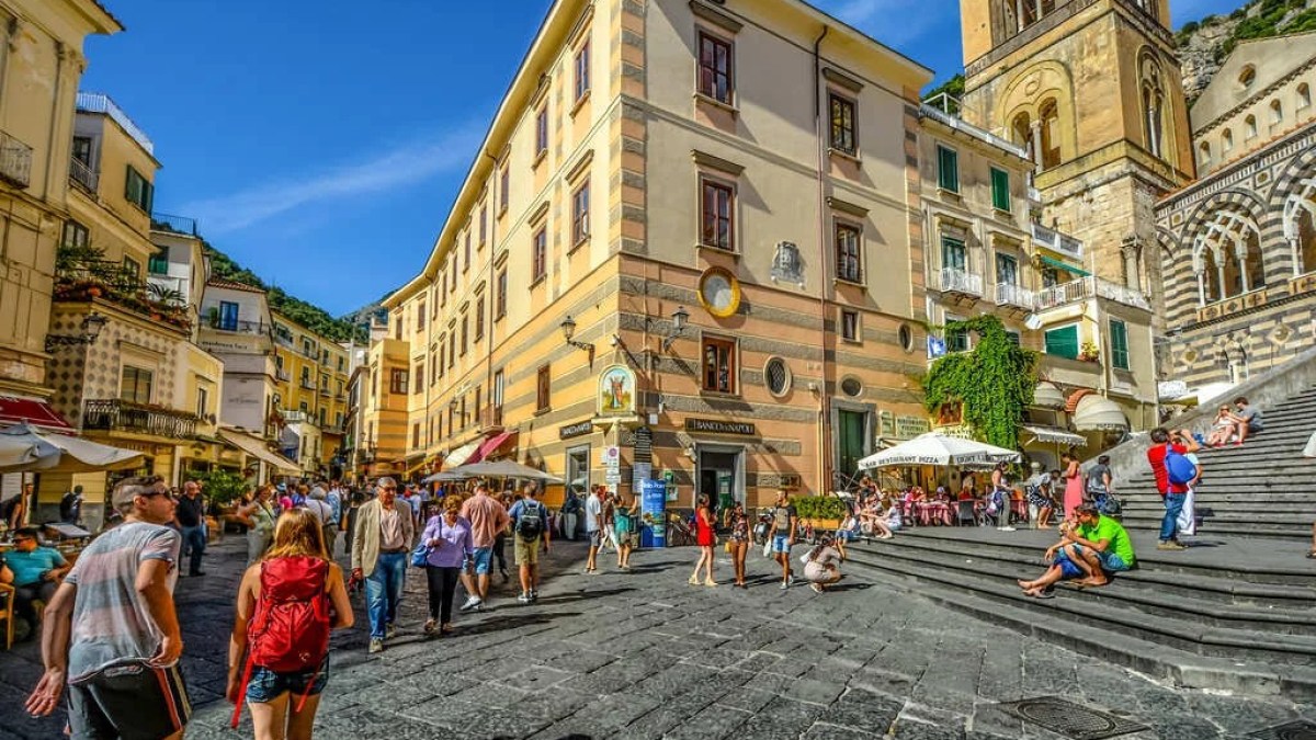 a group of people walking in front of a building