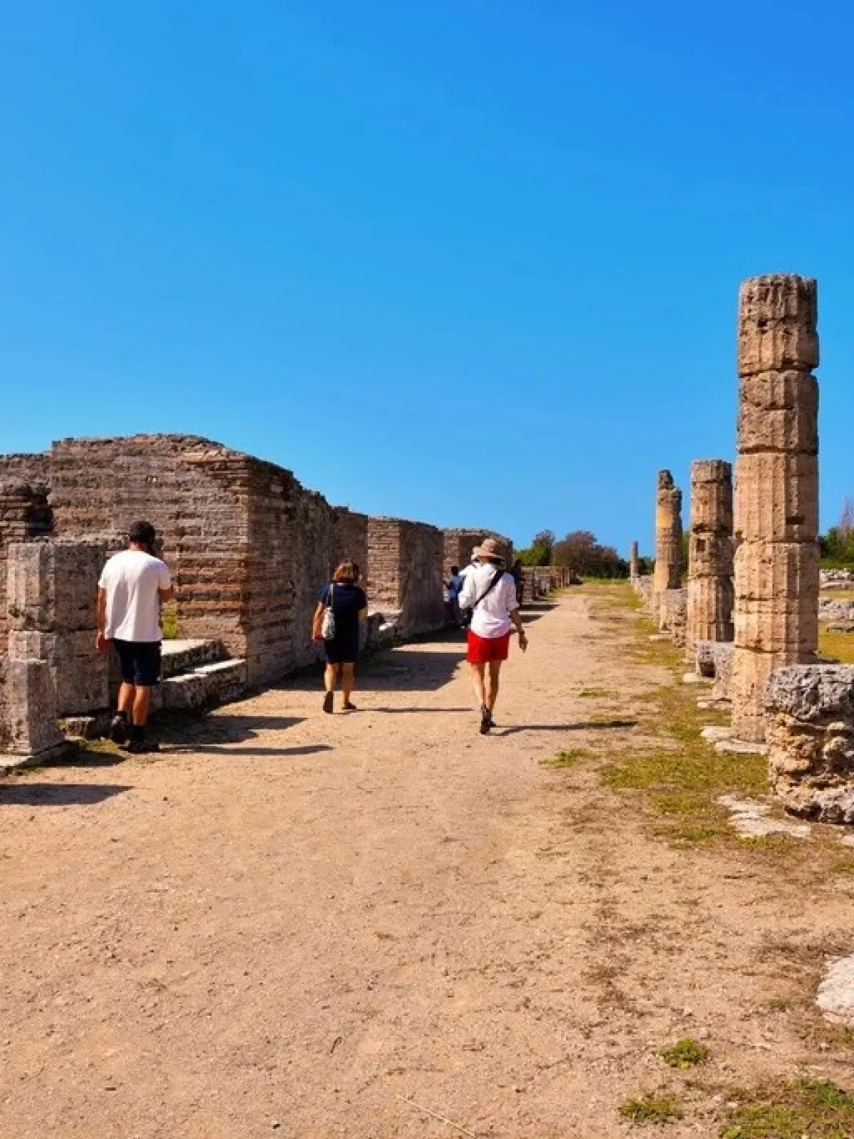 a man standing in front of a stone building