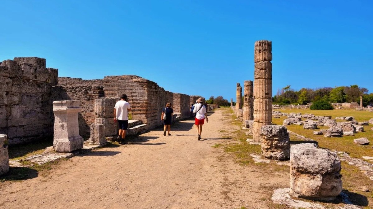 a man standing in front of a stone building