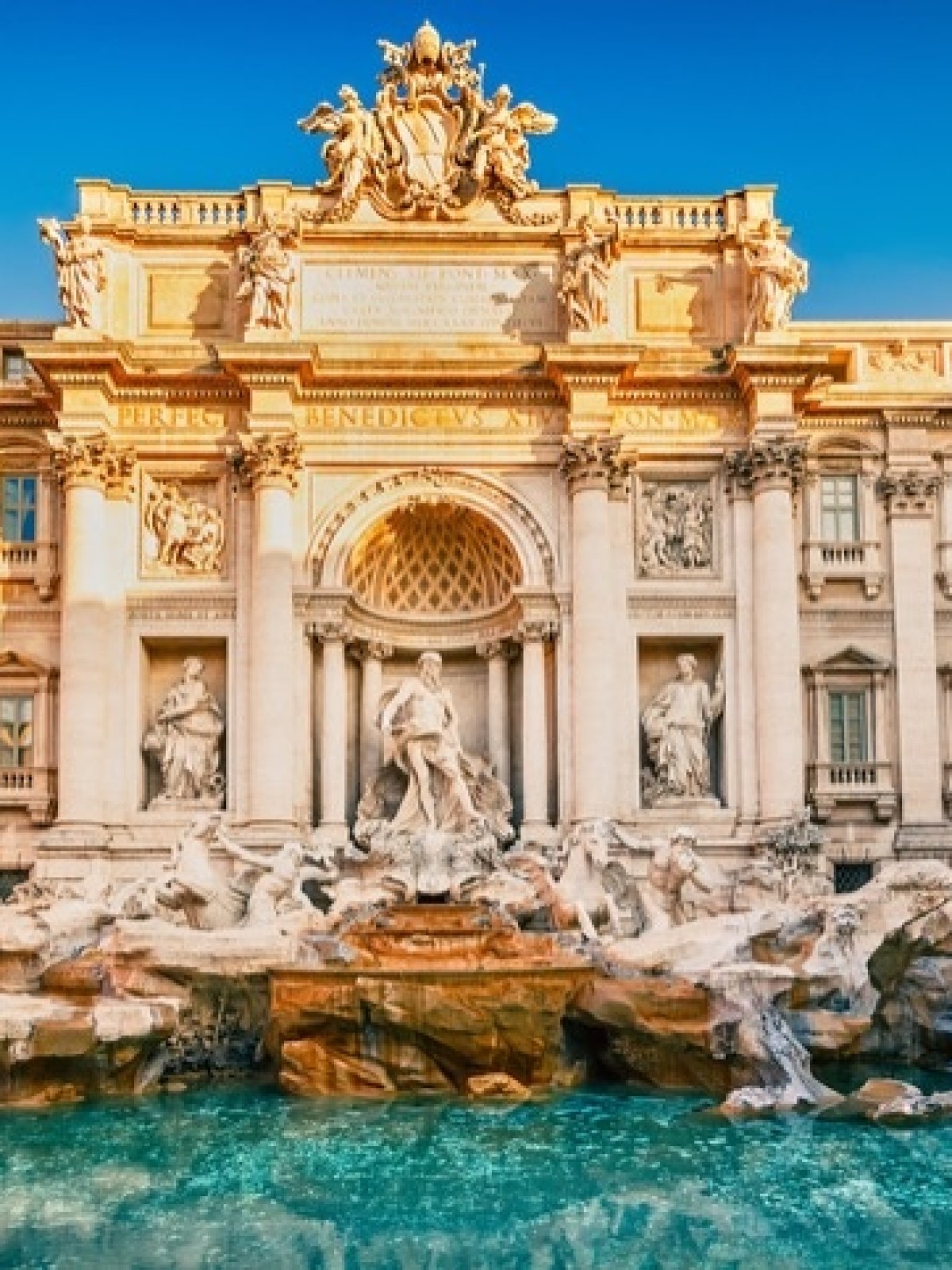 a group of people standing in front of Trevi Fountain