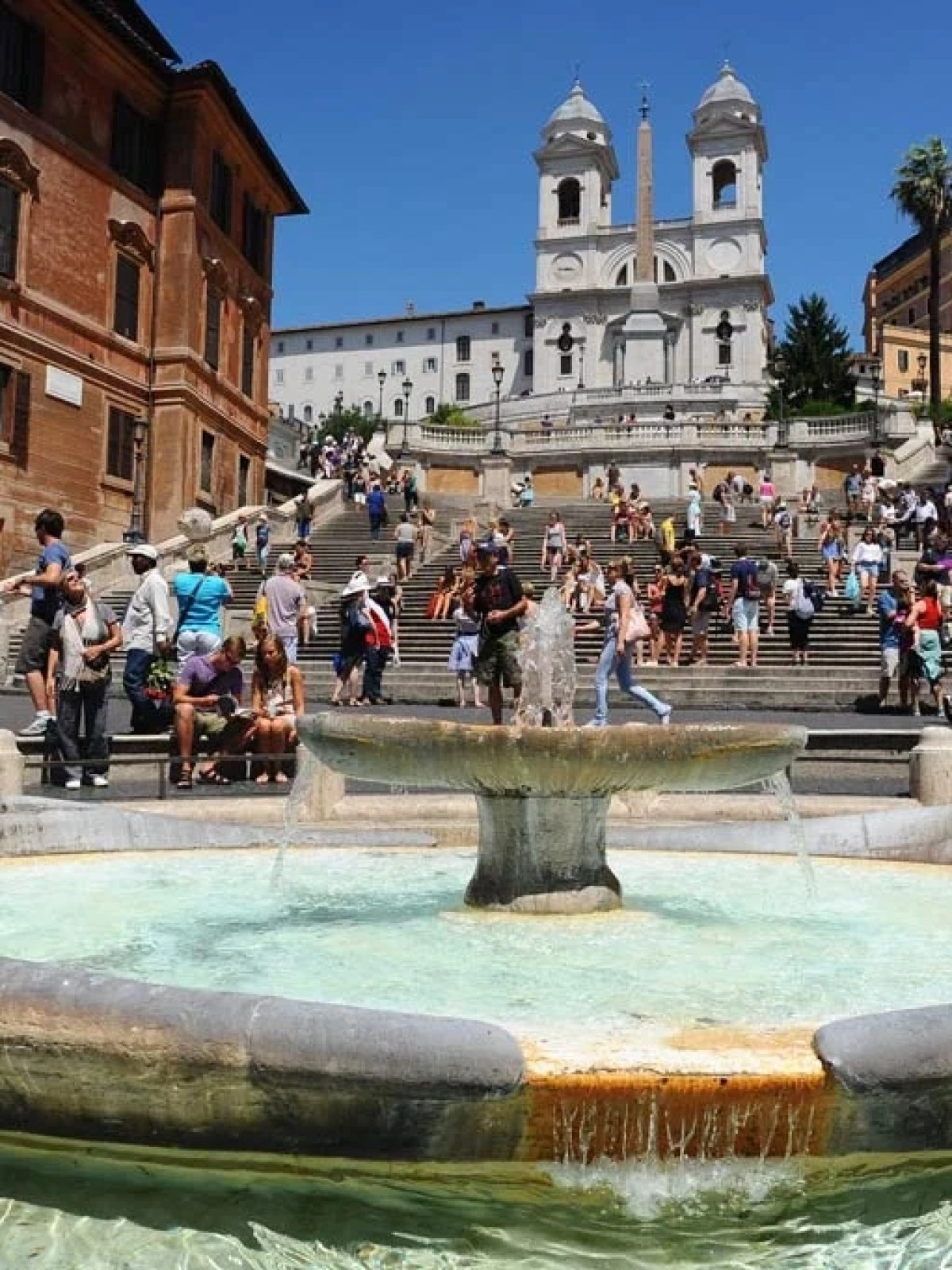 a group of people in a pool of water in front of Spanish Steps