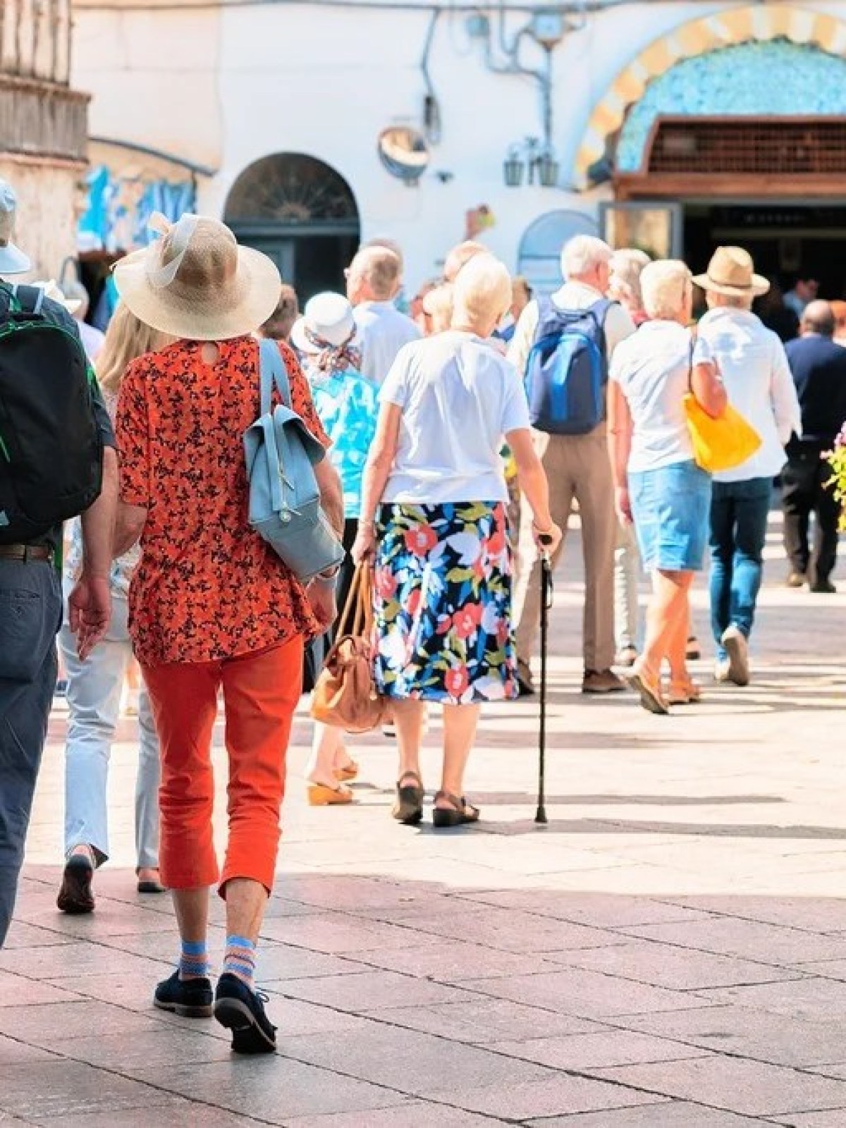 a group of people walking on a sidewalk