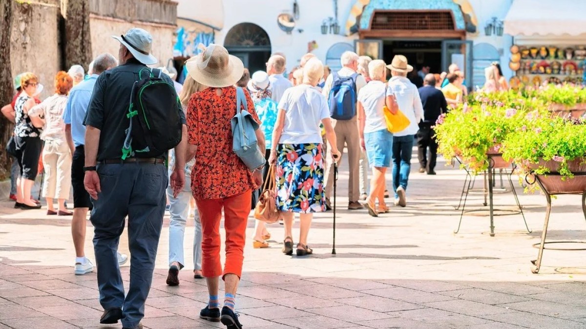 a group of people walking on a sidewalk