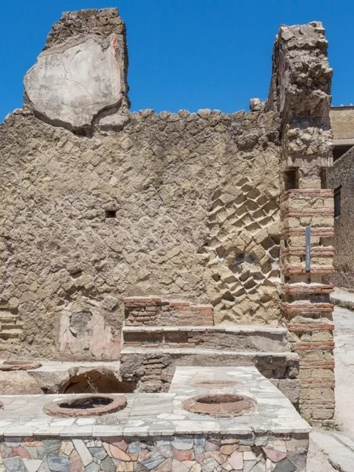 a person standing in front of a stone building