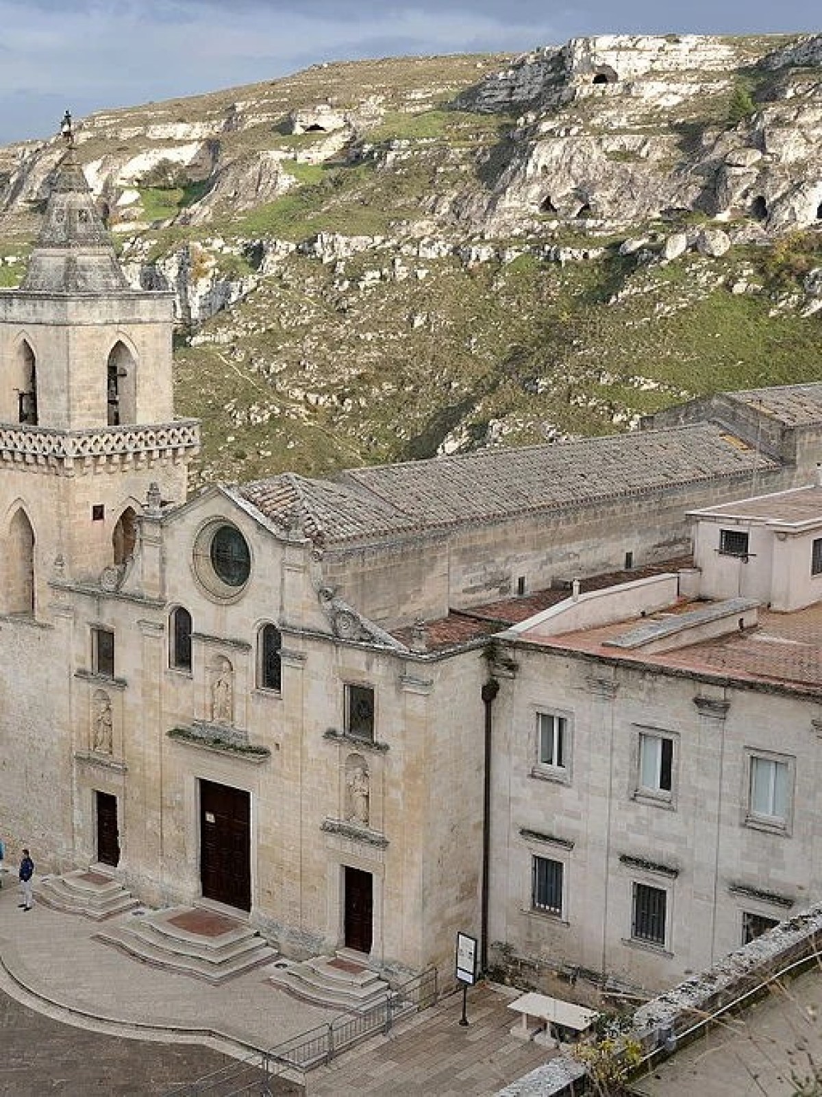 a large stone building with a mountain in the background