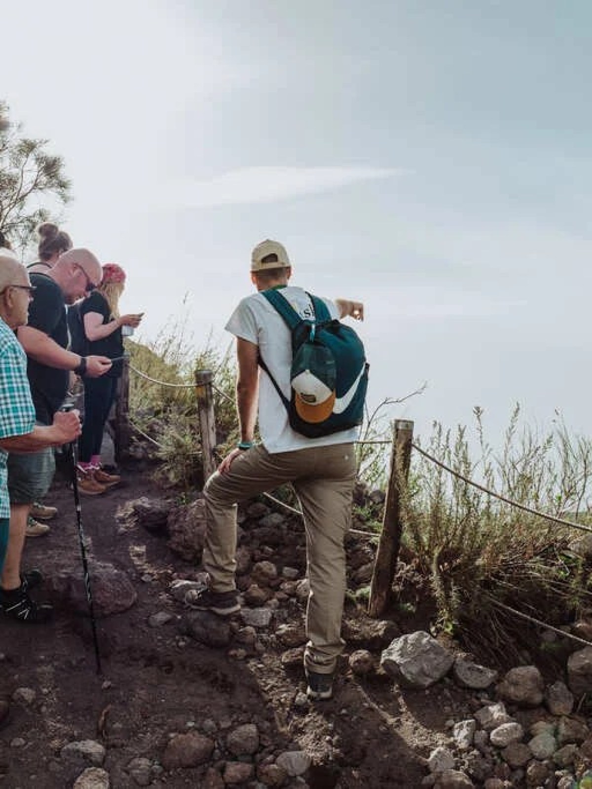 a group of people standing next to a tree