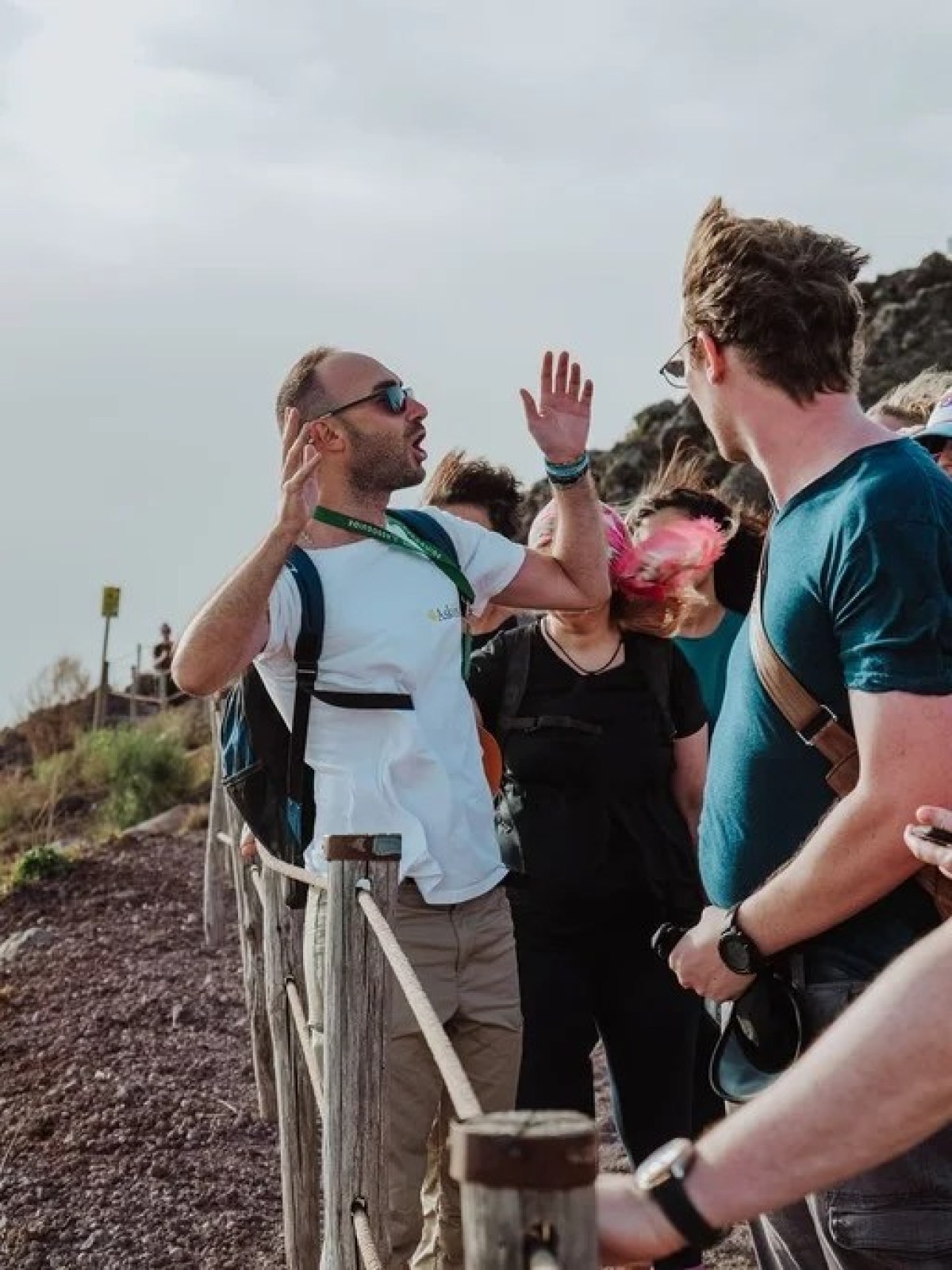 a group of people standing next to a river