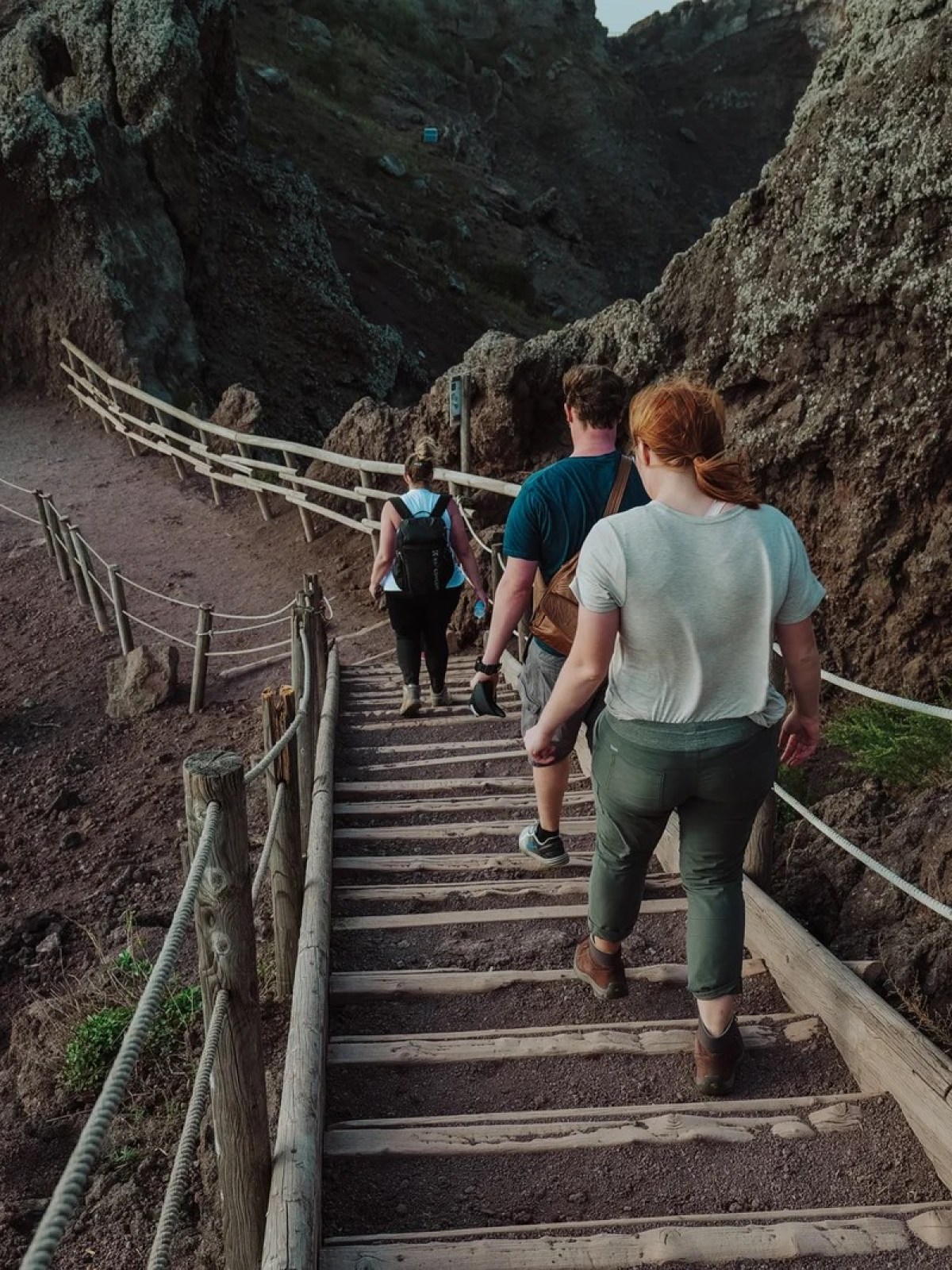 a group of people walking on a bridge