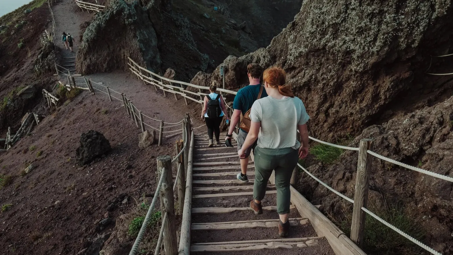 a group of people walking on a bridge
