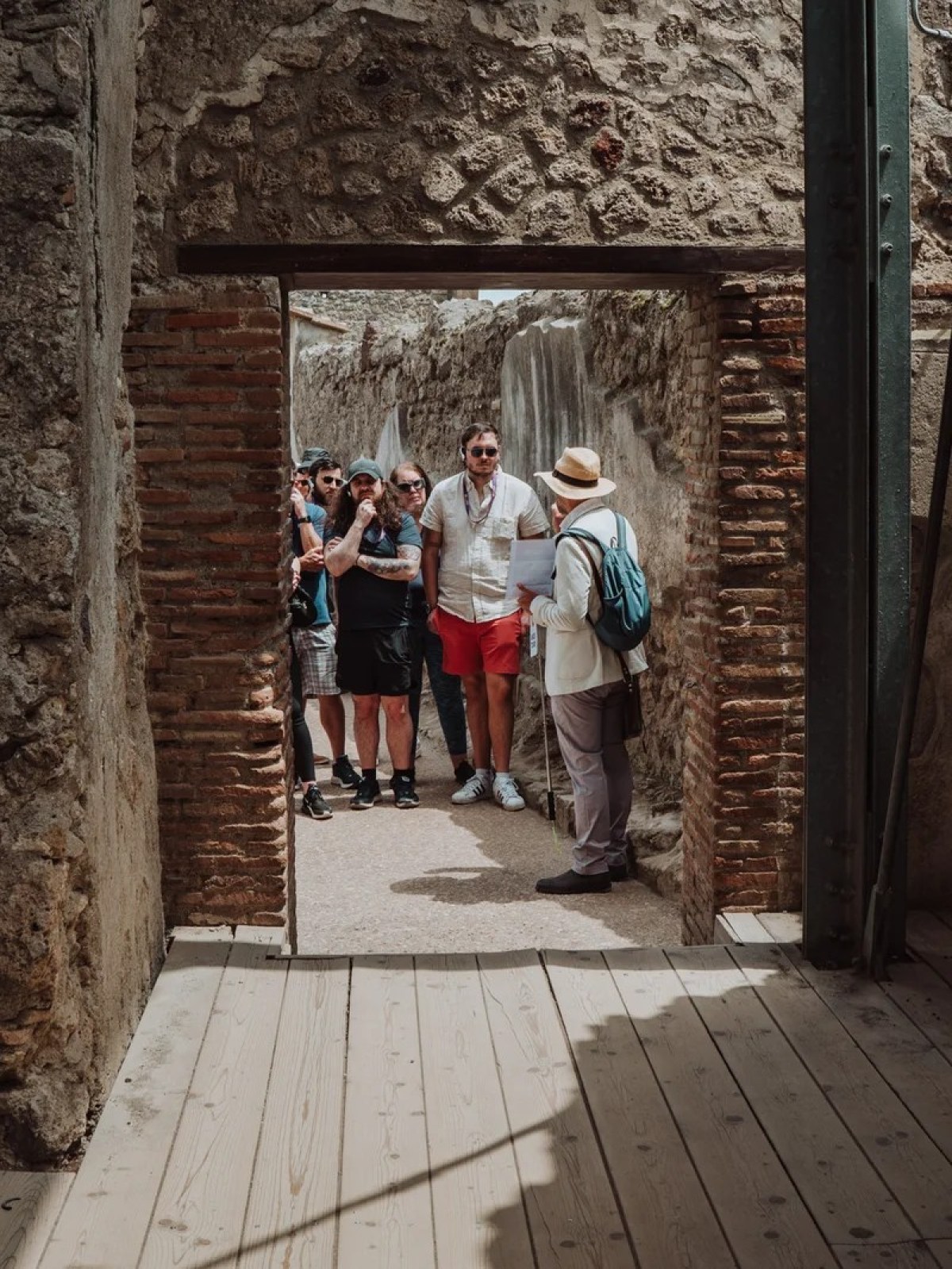 a group of people standing on a sidewalk