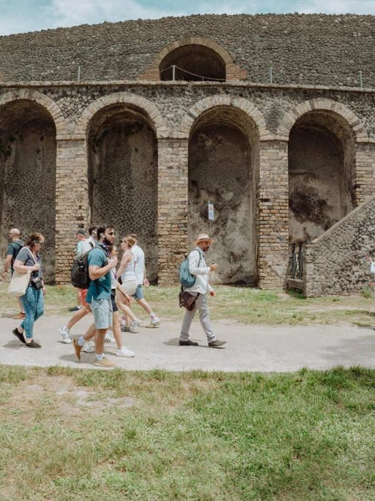 a group of people standing in front of a stone building