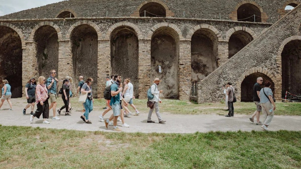 a group of people standing in front of a stone building