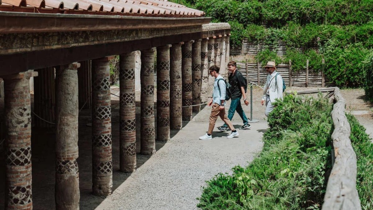 a group of people walking on a bridge