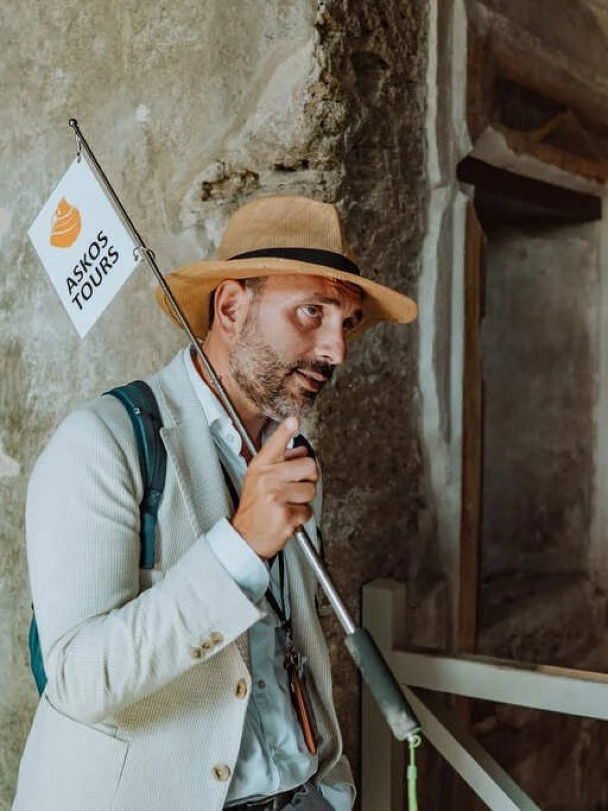 a person wearing a hat in front of a building
