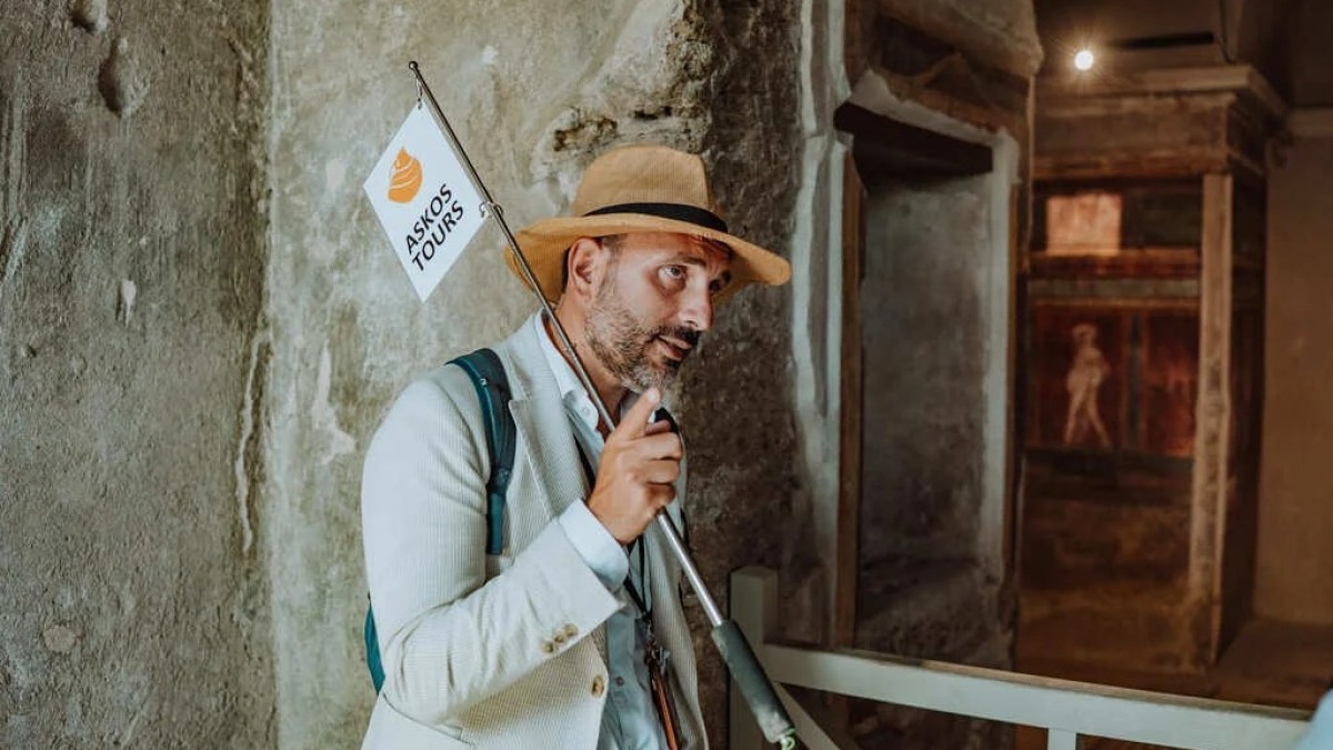 a person wearing a hat in front of a building