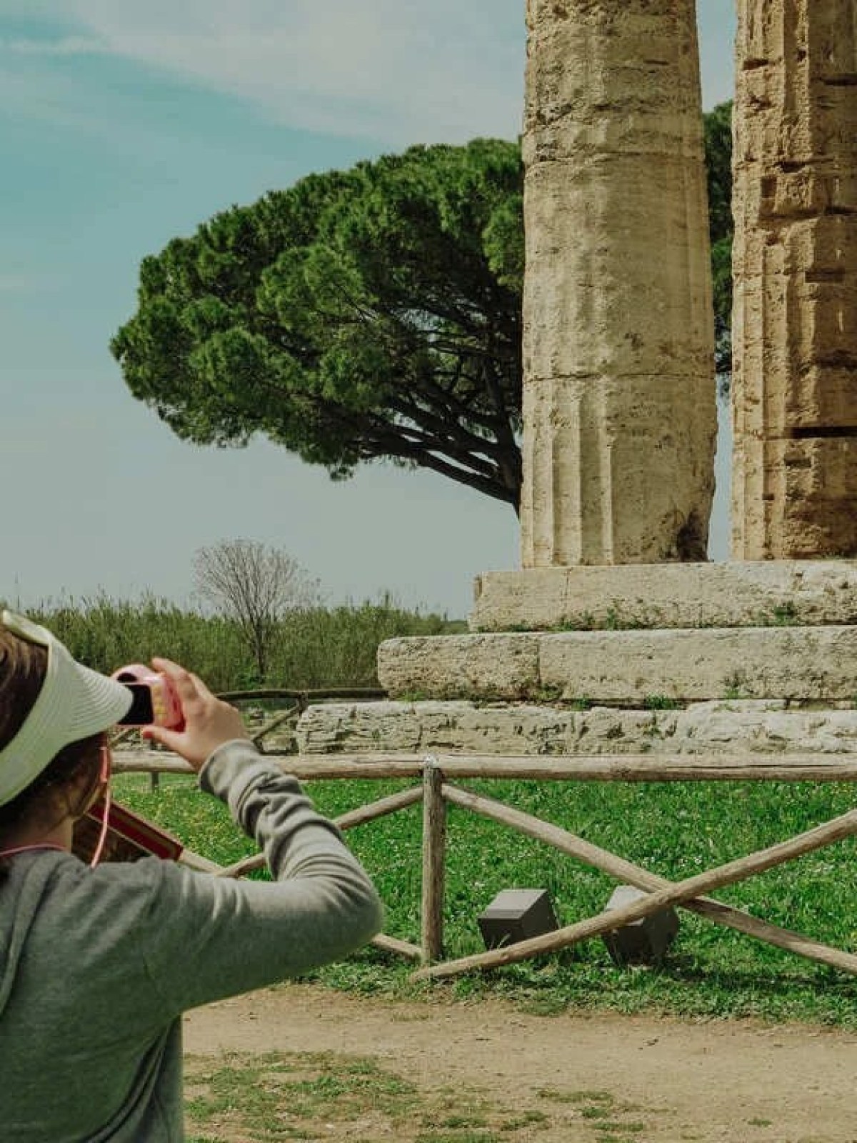 a person standing in front of a fence