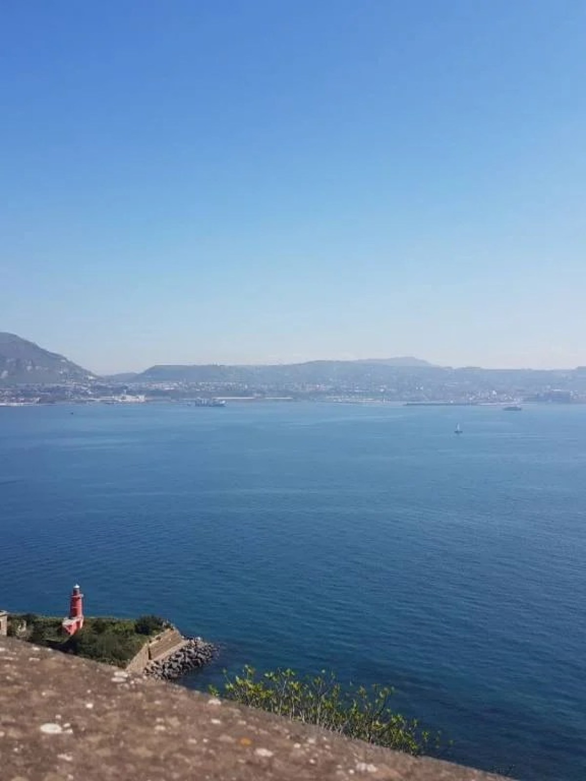 a body of water with a mountain in the background