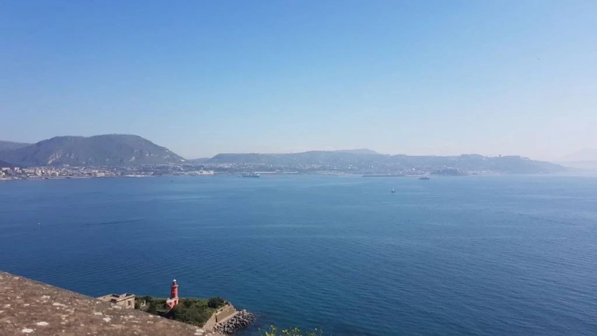 a body of water with a mountain in the background