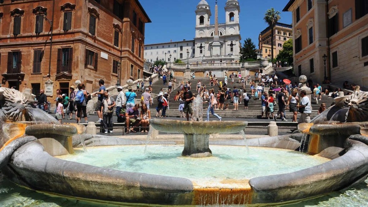 a group of people in a pool of water in front of Spanish Steps