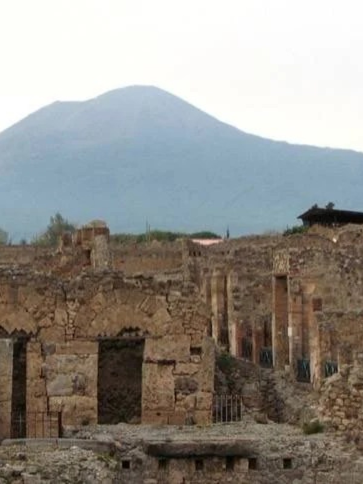 a large stone building with a mountain in the background