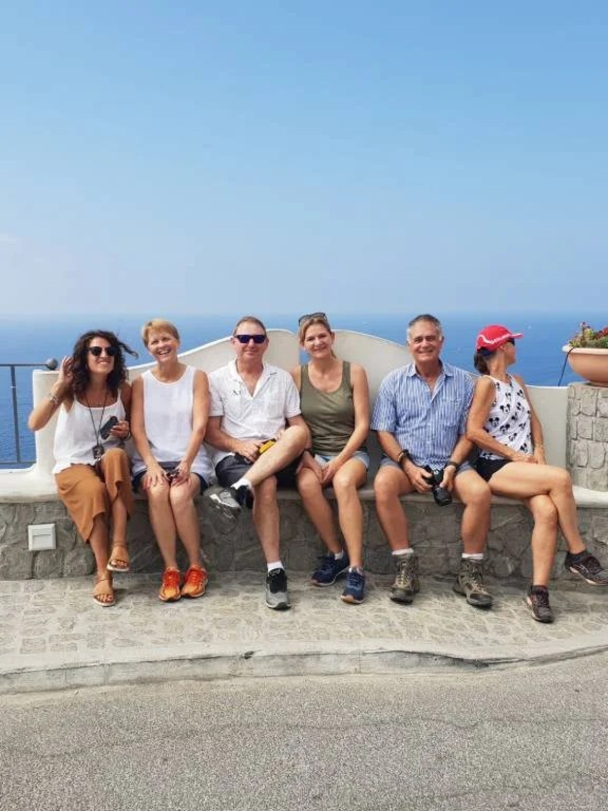 a group of people on a beach posing for the camera