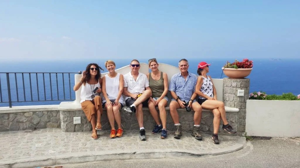 a group of people on a beach posing for the camera