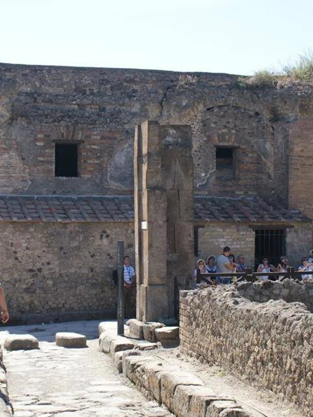 a person standing in front of a stone building