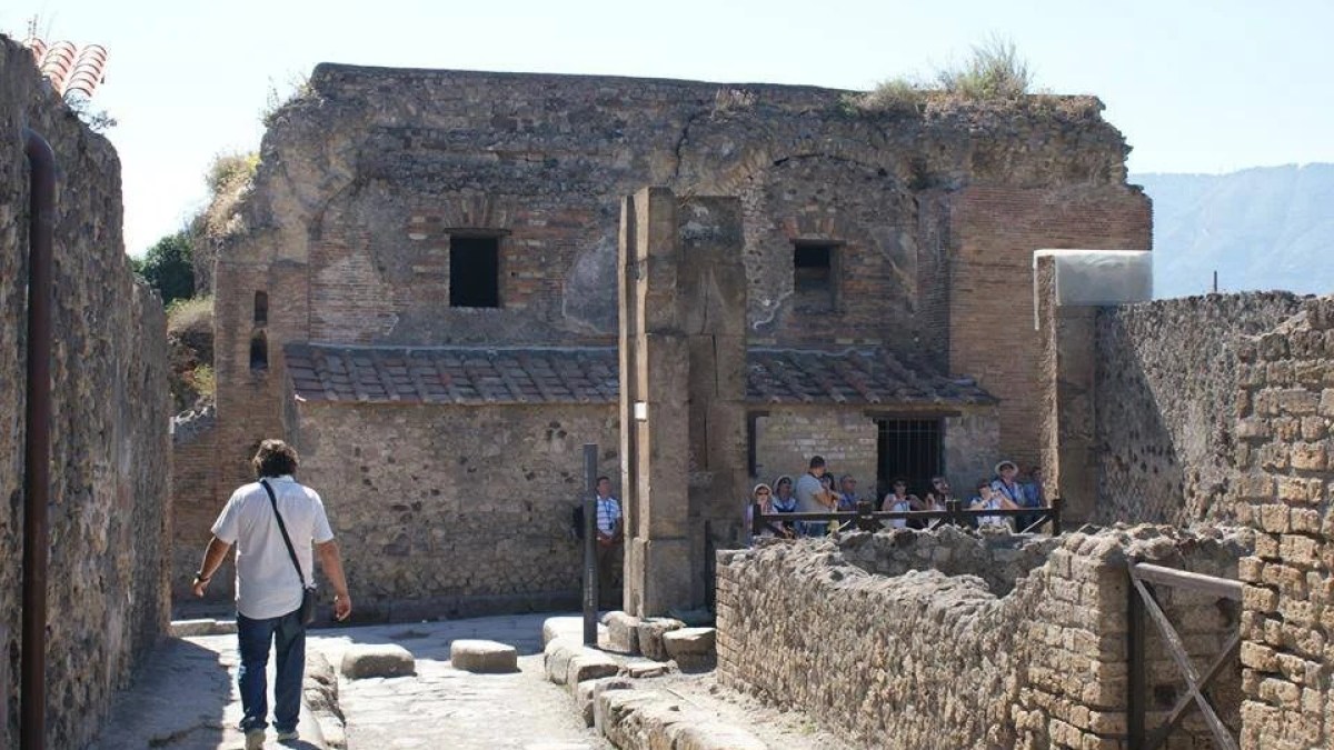 a person standing in front of a stone building