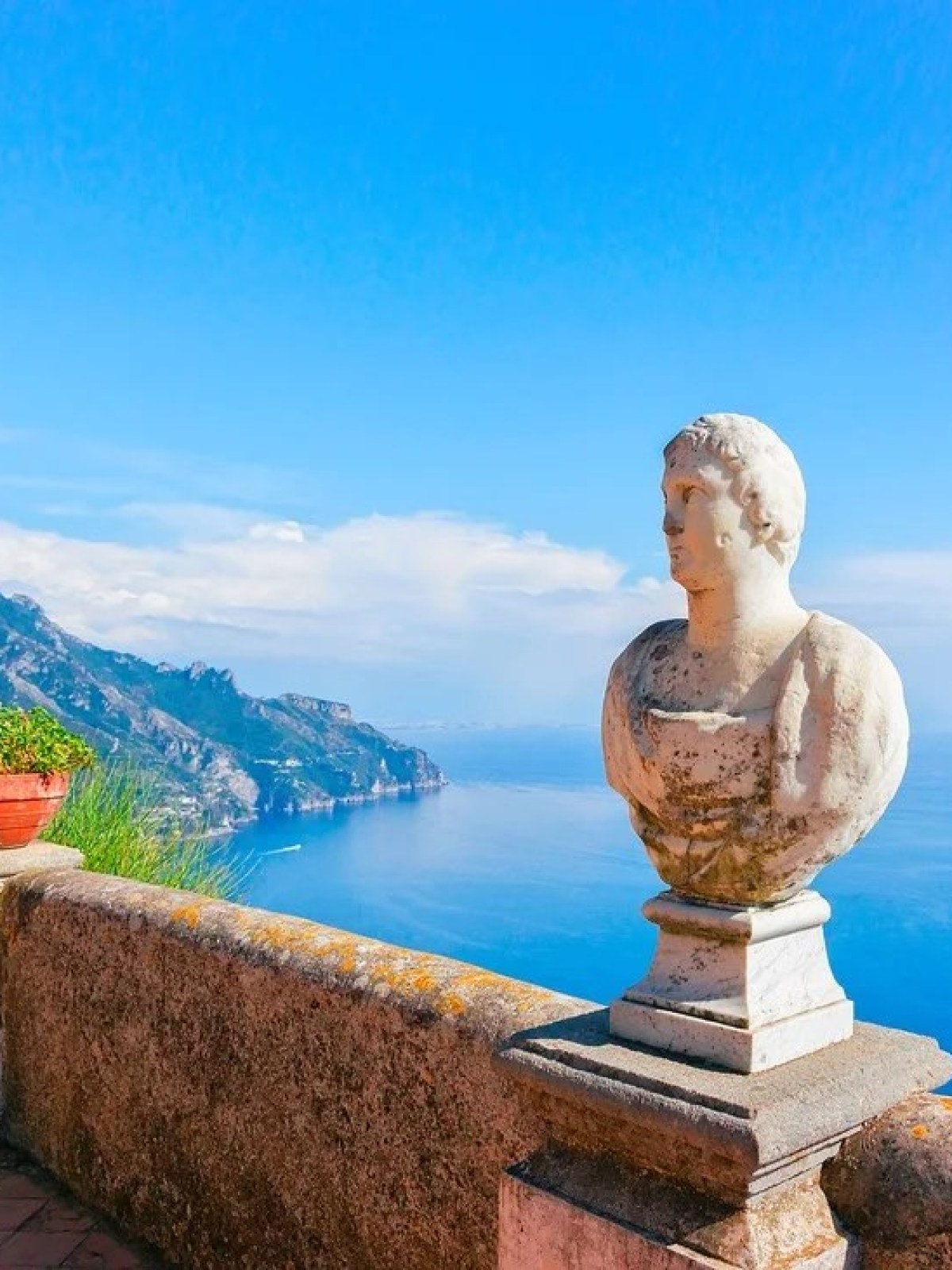 a statue in front of a body of water