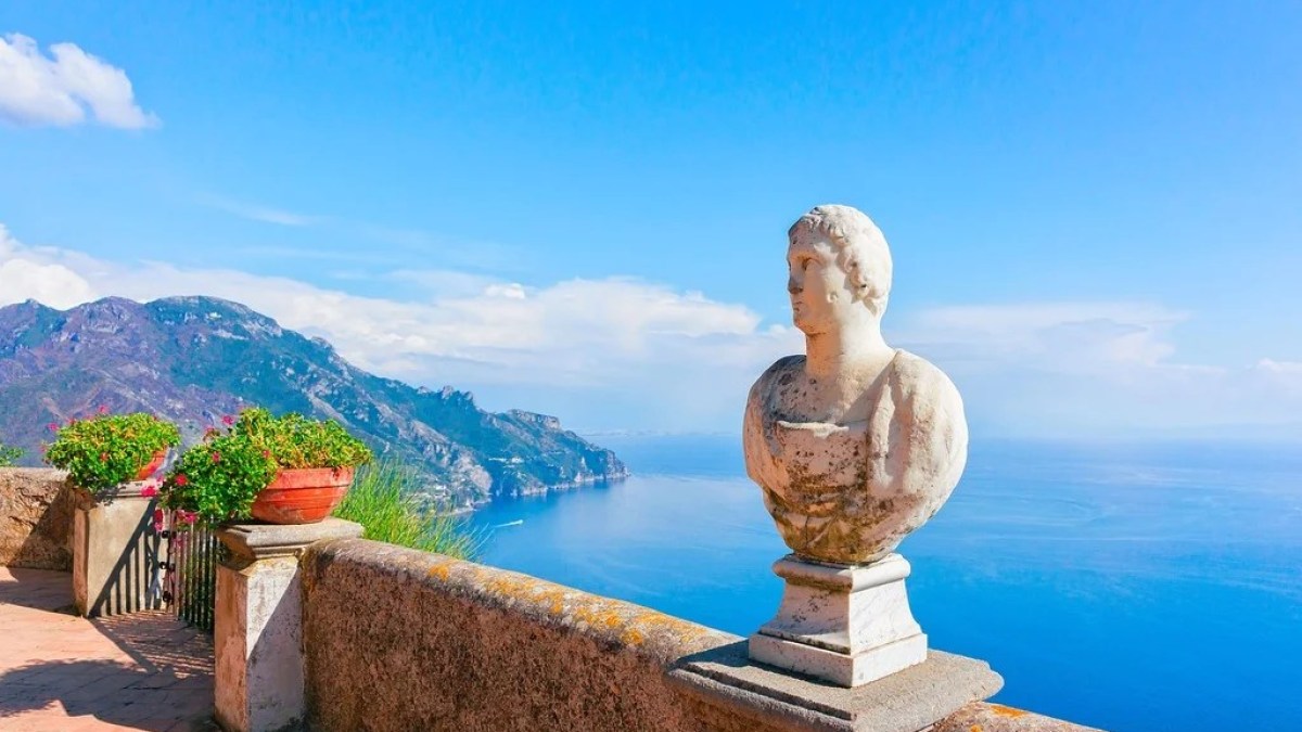 a statue in front of a body of water