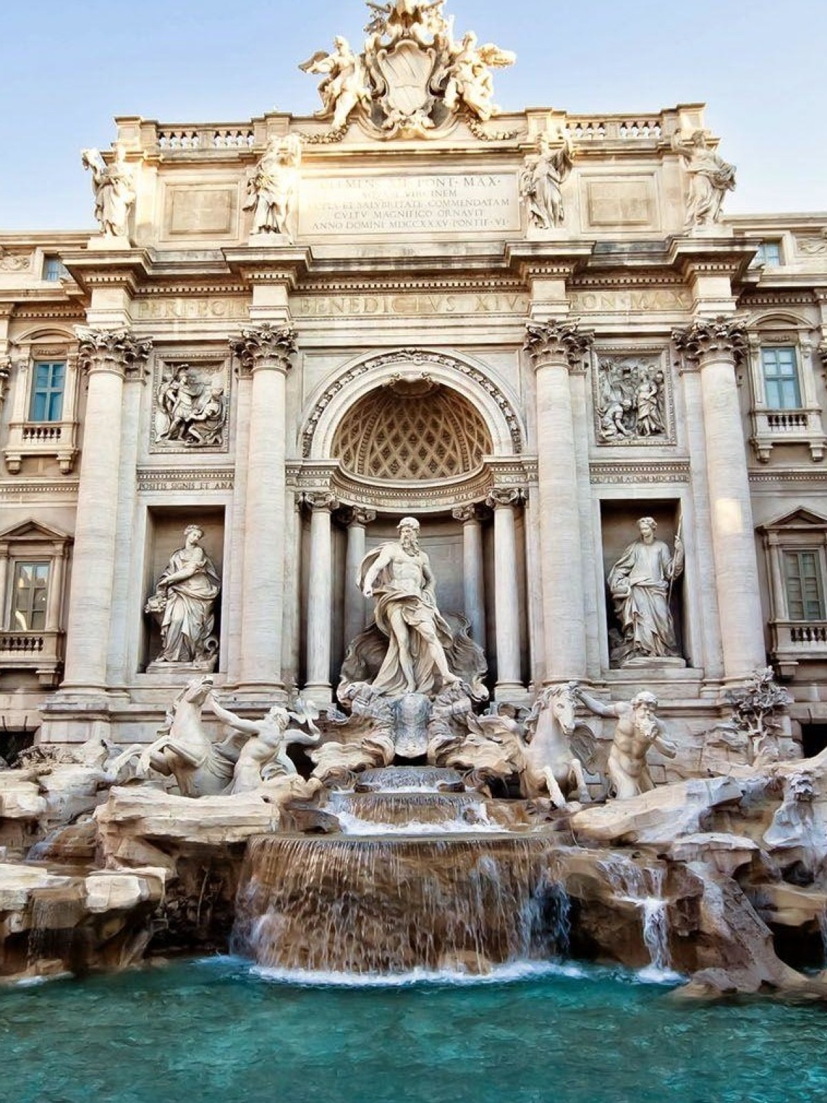 a statue in front of Trevi Fountain