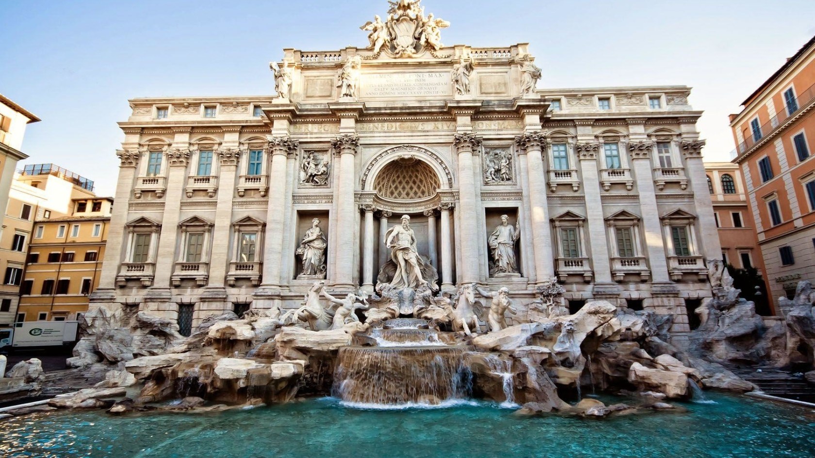 a statue in front of Trevi Fountain