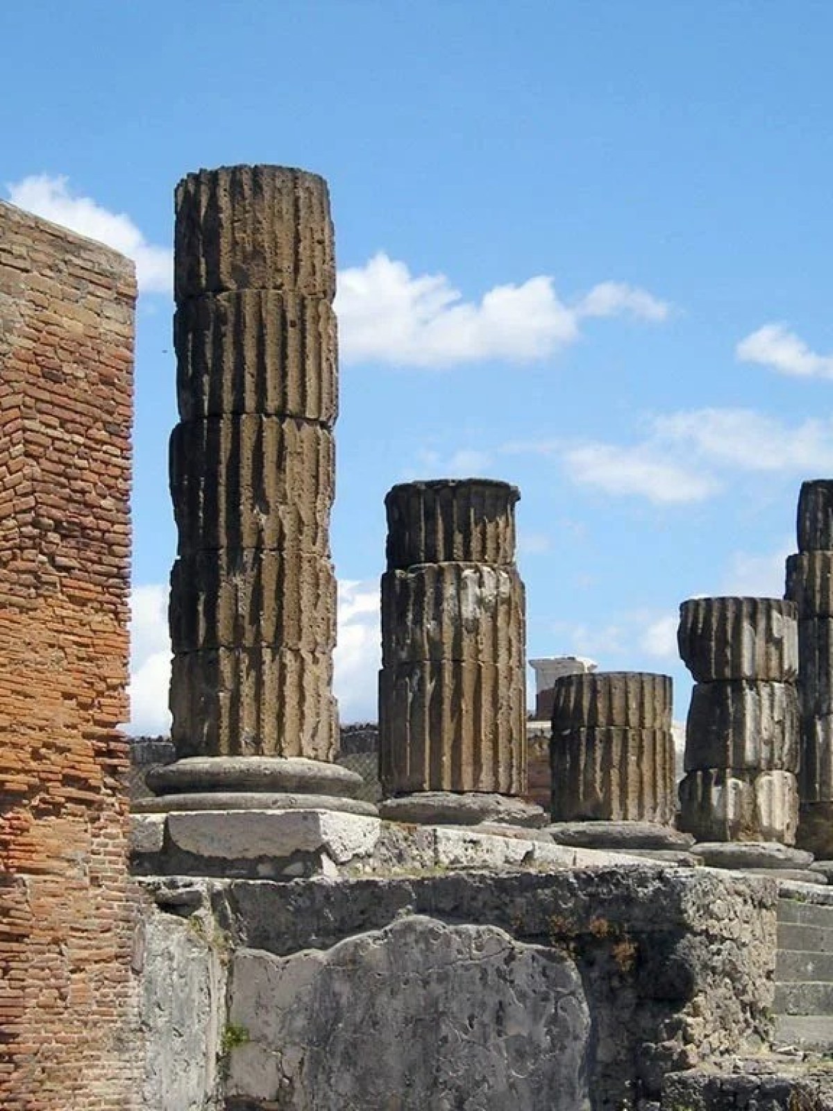 a stone building that has a bridge in the background