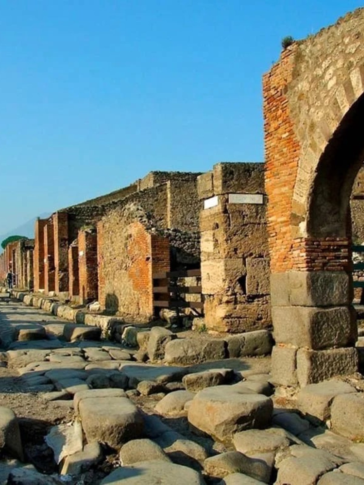 a stone building that has a large rock