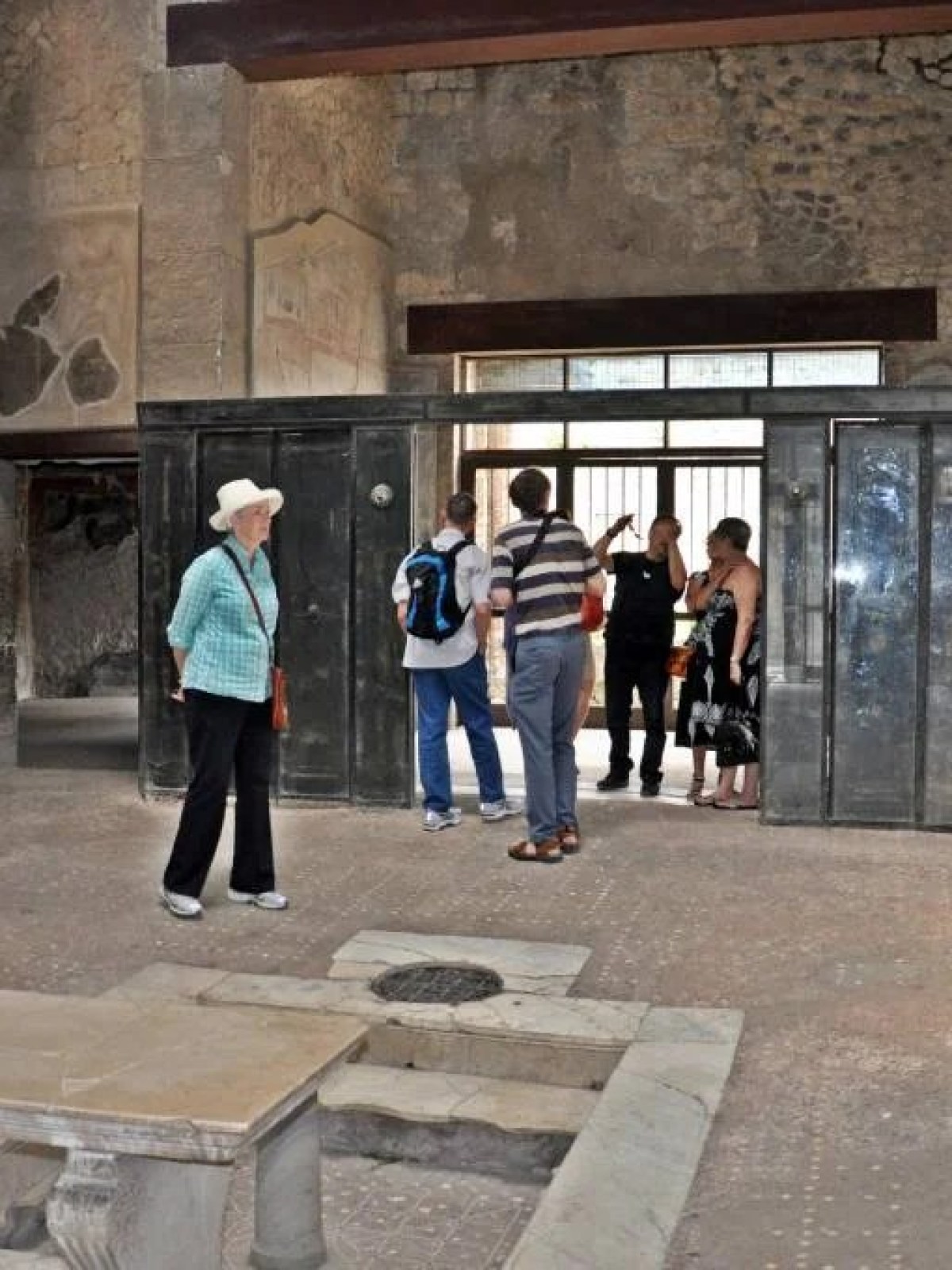 a group of people walking down a sidewalk in front of a building
