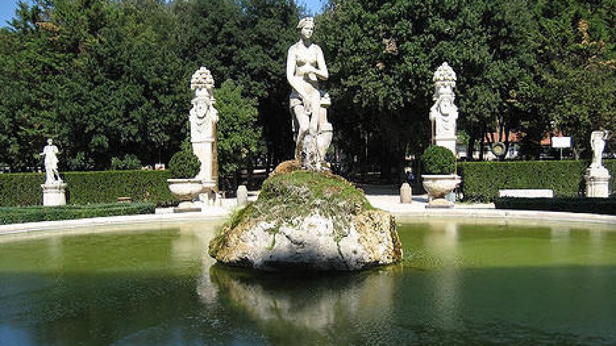 a group of people sitting around a pond