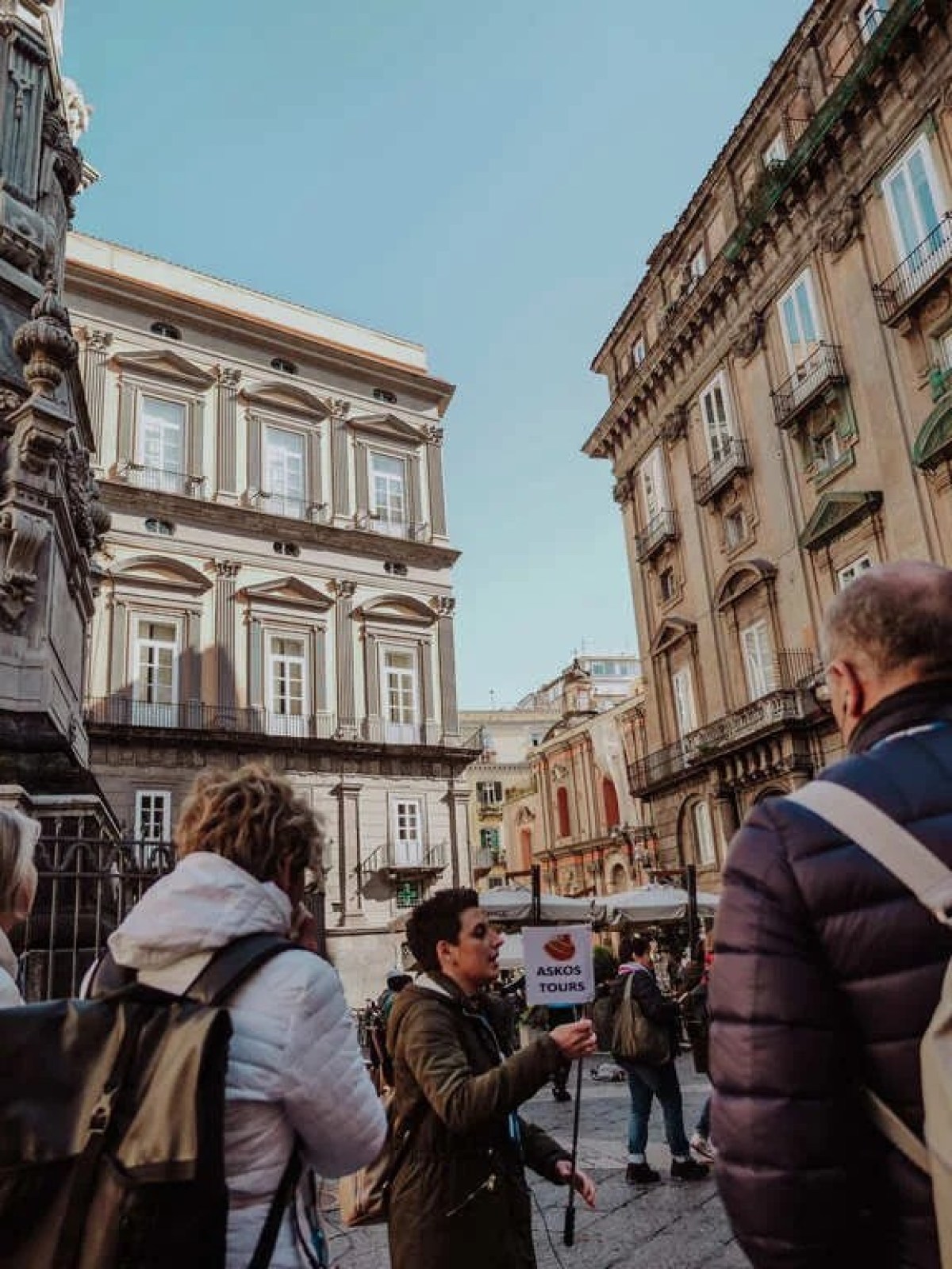a group of people walking in front of a building
