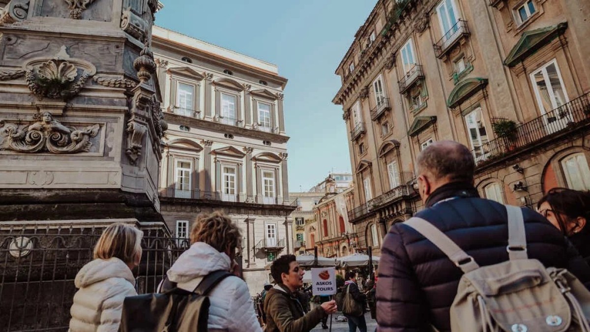 a group of people walking in front of a building
