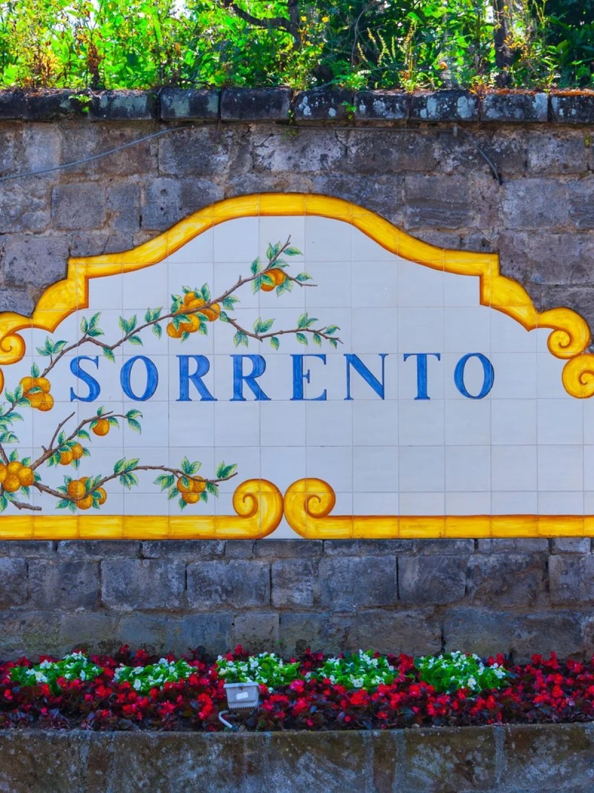 a sign in front of a brick wall