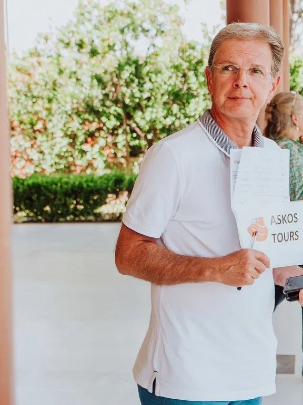 a man holding a sign posing for the camera