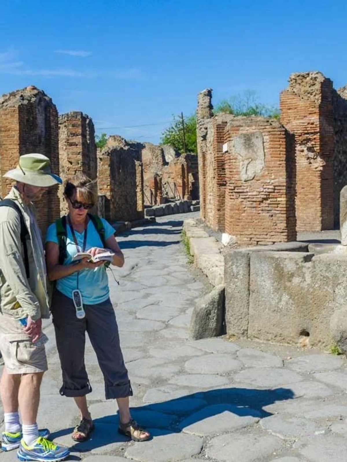 a person standing in front of a stone building