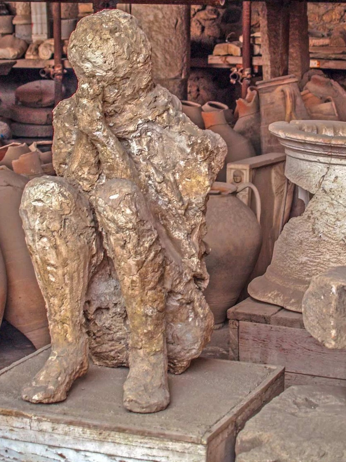 a group of teddy bears sitting next to a statue